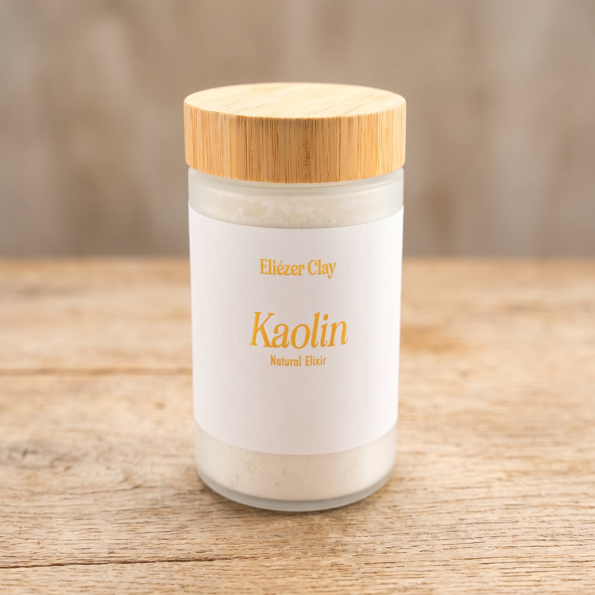 Jar of Eliézer Clay Australian kaolin clay on a pale oak table top